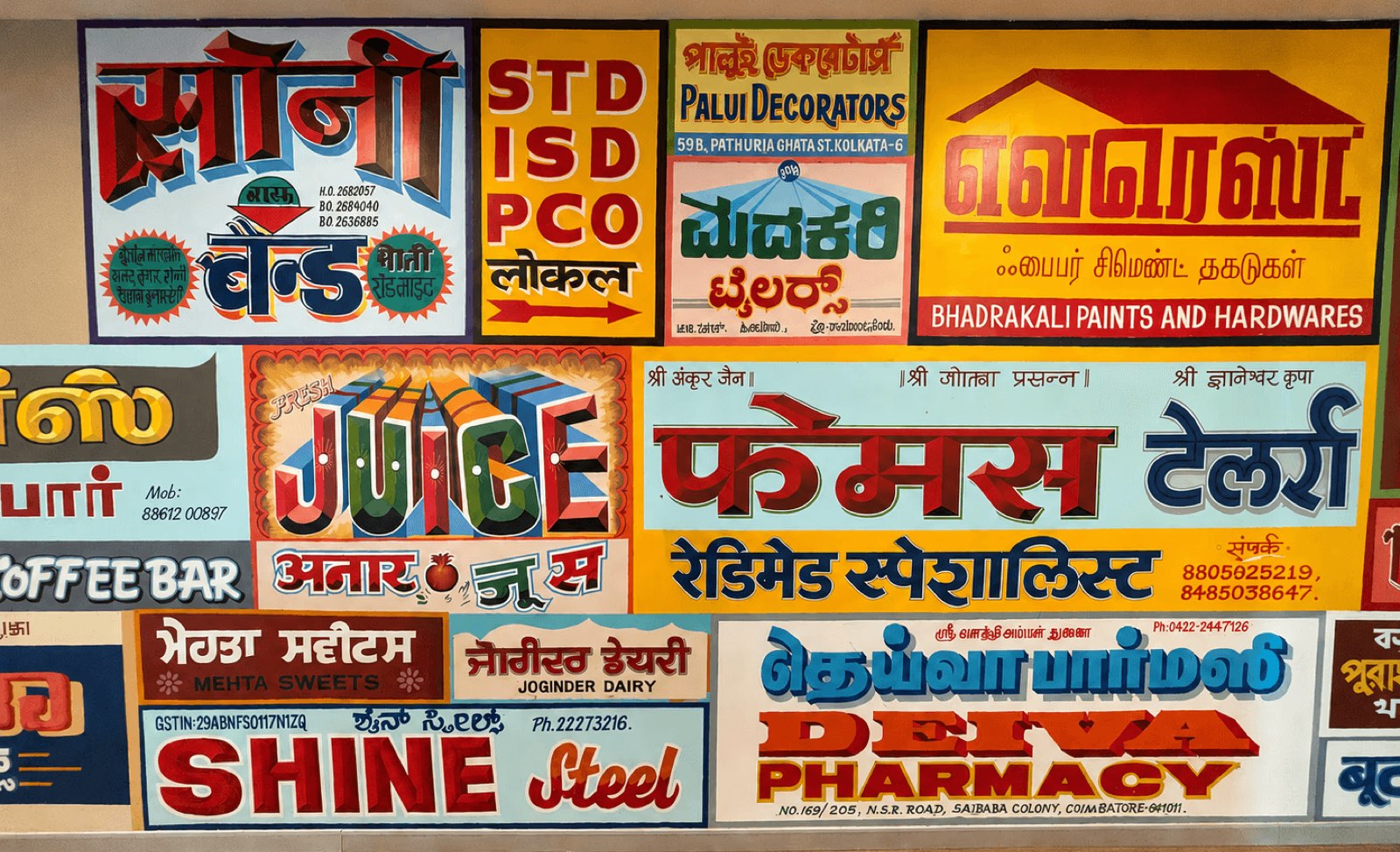 Wall of hand-painted Indian shopfront signboards in Hindi and English